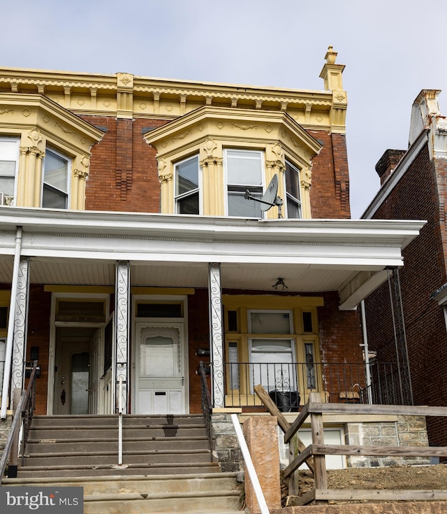 view of front of property with brick siding and a porch