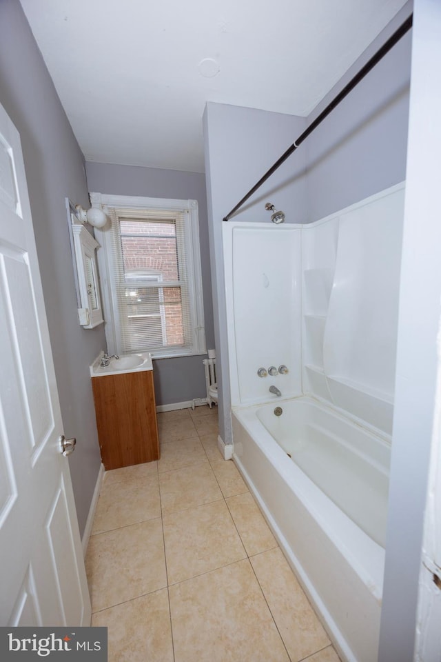 bathroom featuring tile patterned flooring, shower / washtub combination, vanity, and baseboards