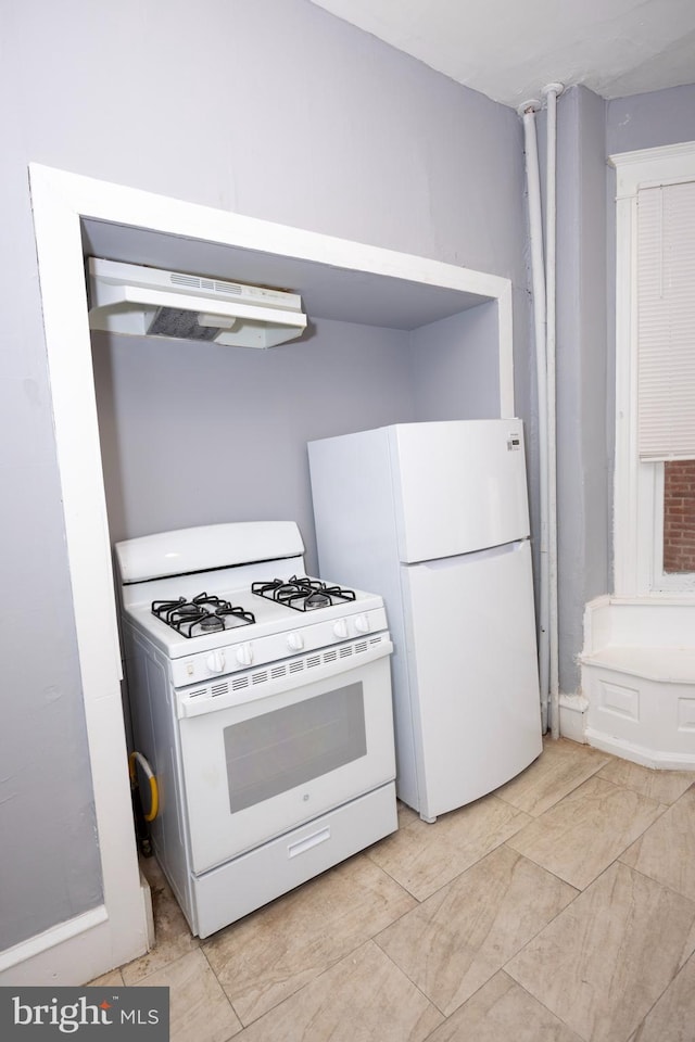 kitchen featuring under cabinet range hood and white appliances