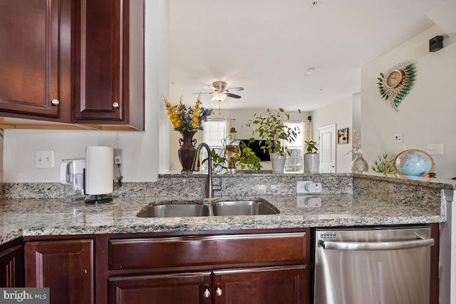 kitchen featuring a sink, reddish brown cabinets, light stone countertops, dishwasher, and ceiling fan