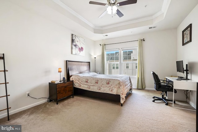 bedroom featuring a tray ceiling, visible vents, and light carpet