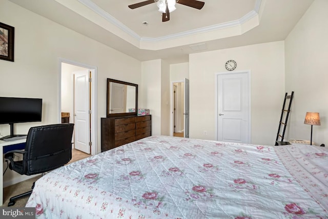 bedroom with crown molding, carpet, a raised ceiling, and a ceiling fan