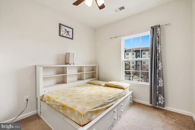 bedroom featuring a ceiling fan, baseboards, visible vents, and carpet floors