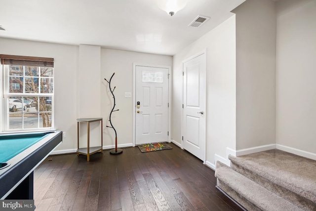 entryway with billiards, stairway, baseboards, visible vents, and dark wood finished floors