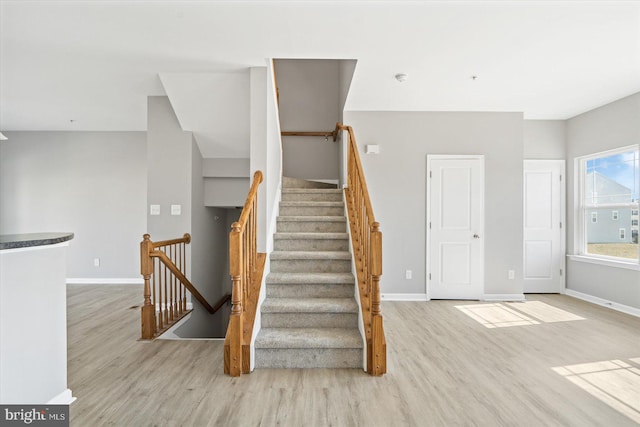 stairs featuring baseboards and wood finished floors