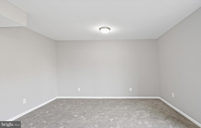 spare room with carpet flooring and baseboards