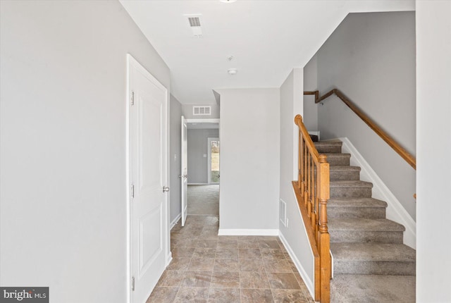 stairs featuring baseboards and visible vents