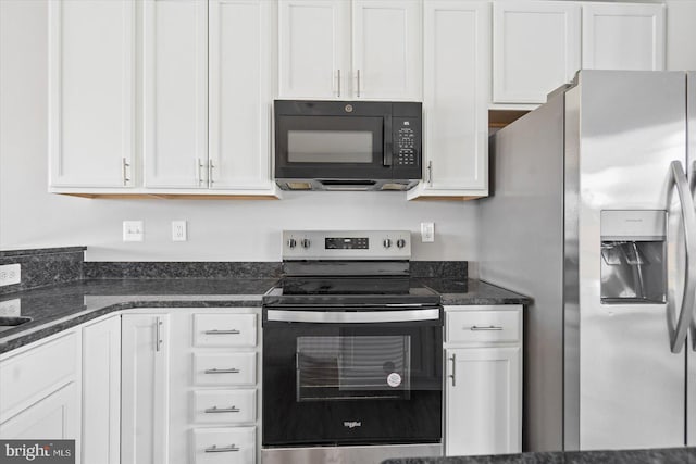 kitchen featuring dark stone counters, white cabinets, and stainless steel appliances