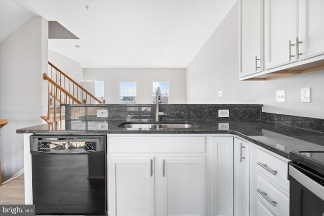 kitchen featuring a sink, white cabinetry, dark stone counters, a peninsula, and dishwasher