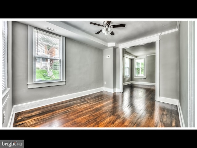 unfurnished room featuring visible vents, ceiling fan, baseboards, and hardwood / wood-style flooring