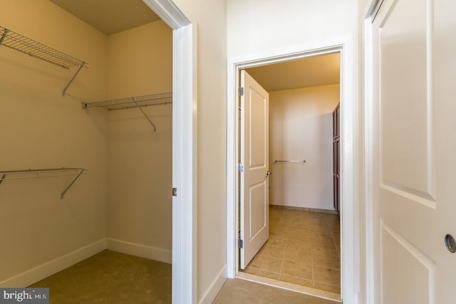 spacious closet featuring tile patterned floors