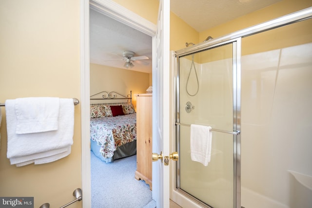 ensuite bathroom with a ceiling fan, ensuite bath, a shower stall, and a textured ceiling