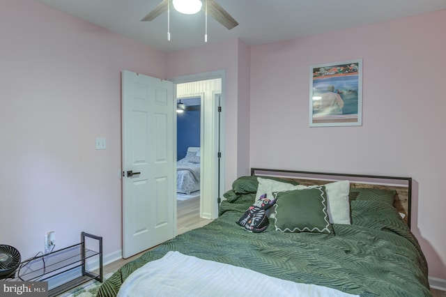 bedroom with baseboards, ceiling fan, and wood finished floors