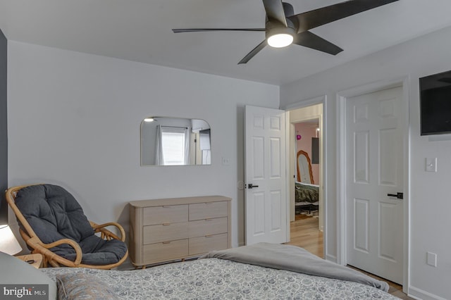 bedroom with a ceiling fan and light wood-style floors