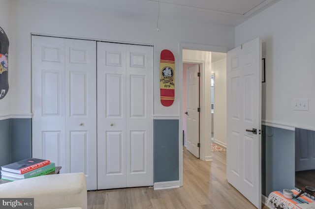 bedroom featuring light wood-type flooring and a closet