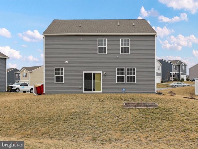 back of property featuring a lawn