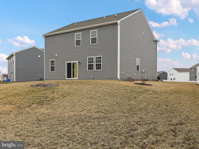 back of house featuring a lawn