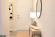 hallway with tile patterned flooring