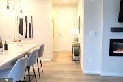 interior space featuring baseboards, wood finished floors, and a breakfast bar area