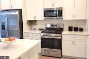 kitchen with decorative backsplash, appliances with stainless steel finishes, and light countertops