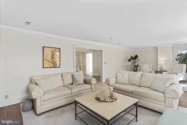 living area with baseboards, light wood-type flooring, and ornamental molding