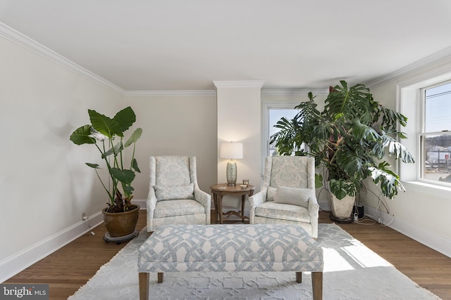 sitting room with crown molding, wood finished floors, and baseboards