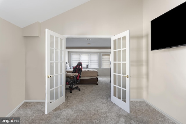 carpeted office featuring french doors, baseboards, and vaulted ceiling