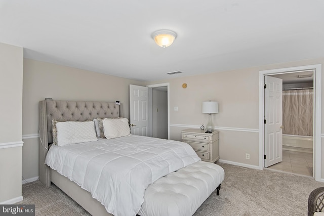 bedroom featuring visible vents, carpet floors, baseboards, and ensuite bathroom