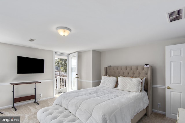 carpeted bedroom featuring visible vents, baseboards, and access to outside