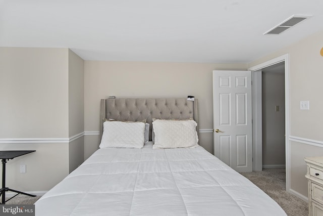 bedroom with carpet, visible vents, and baseboards