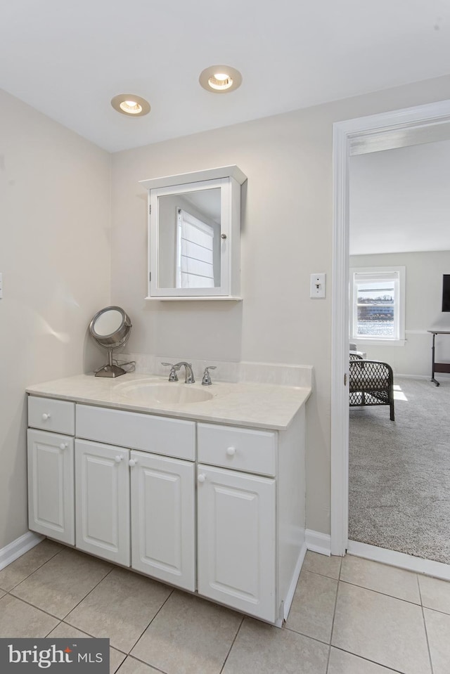 bathroom with vanity, tile patterned floors, recessed lighting, and baseboards