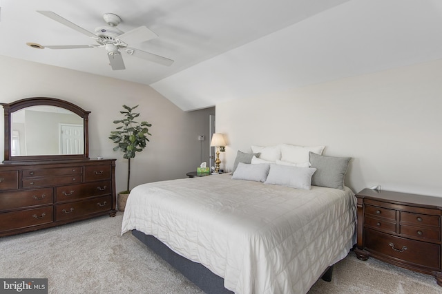 bedroom with light carpet, a ceiling fan, and vaulted ceiling