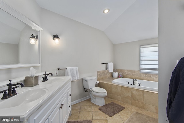 full bath with tile patterned floors, vaulted ceiling, a garden tub, and a sink