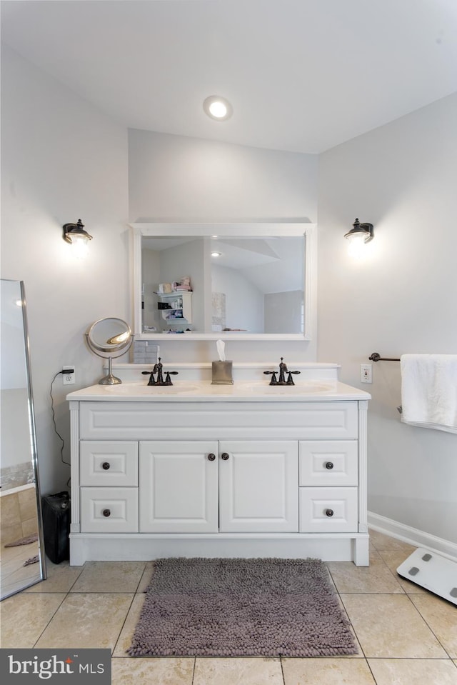 bathroom with double vanity, tile patterned floors, and a sink