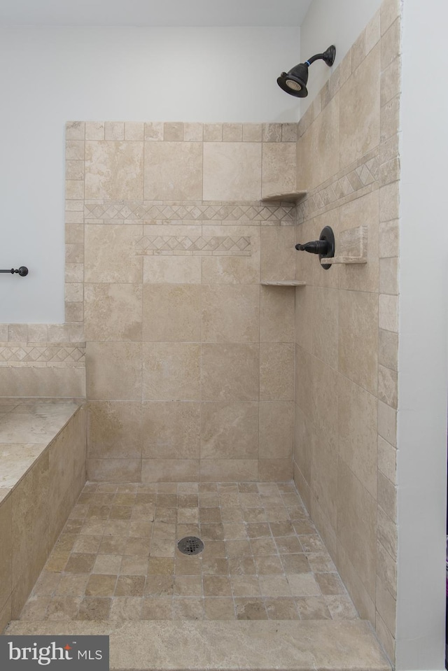 bathroom with tiled shower