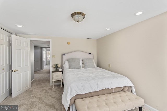 bedroom with recessed lighting, visible vents, baseboards, and light colored carpet