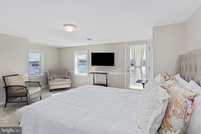 carpeted bedroom featuring visible vents and baseboards