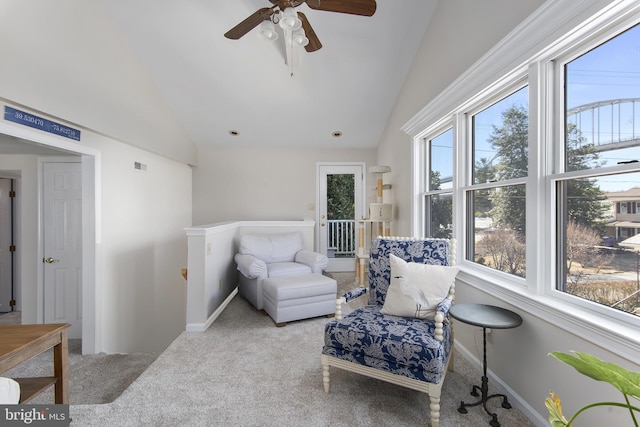 living area with visible vents, an upstairs landing, a ceiling fan, carpet, and lofted ceiling