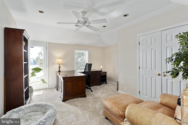 home office featuring baseboards, light carpet, and ceiling fan