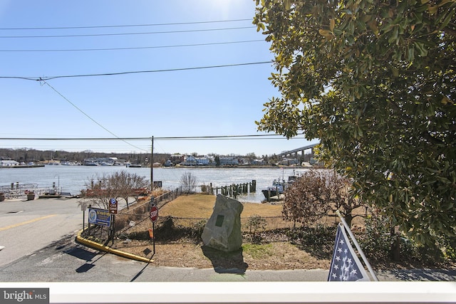 view of yard with a water view and fence