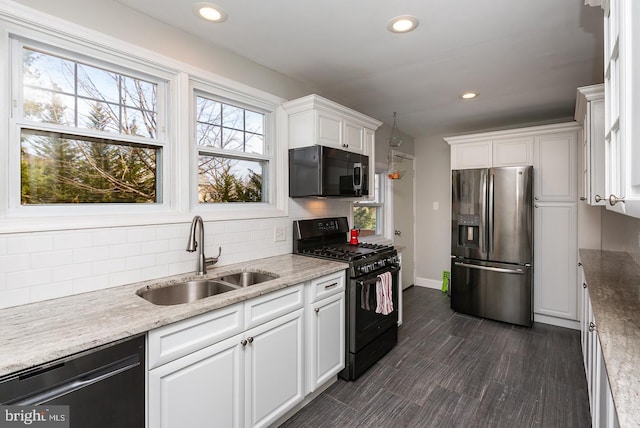 kitchen with black appliances, a sink, backsplash, recessed lighting, and white cabinets