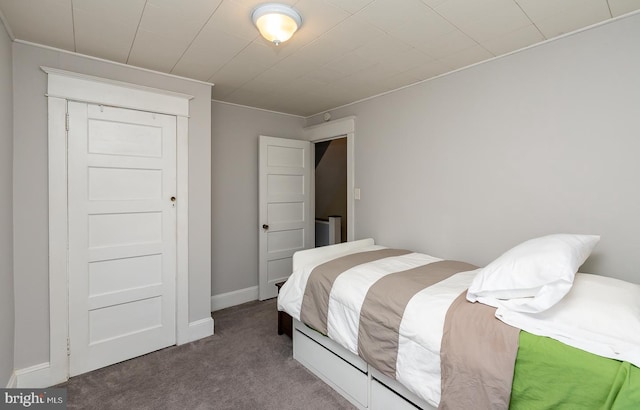 carpeted bedroom featuring baseboards