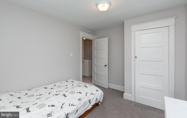 carpeted bedroom featuring baseboards