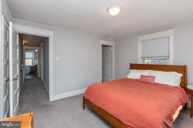 bedroom with carpet flooring and baseboards