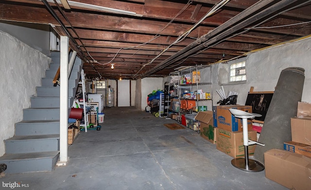 below grade area featuring stairway and water heater