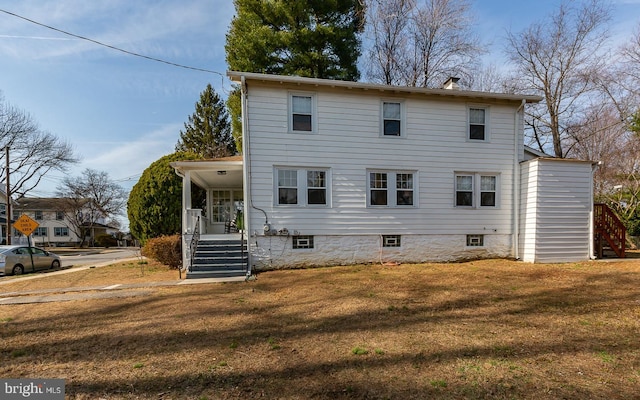 view of front of house with a front yard and stairway