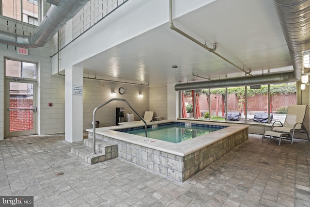 view of swimming pool featuring a patio and fence