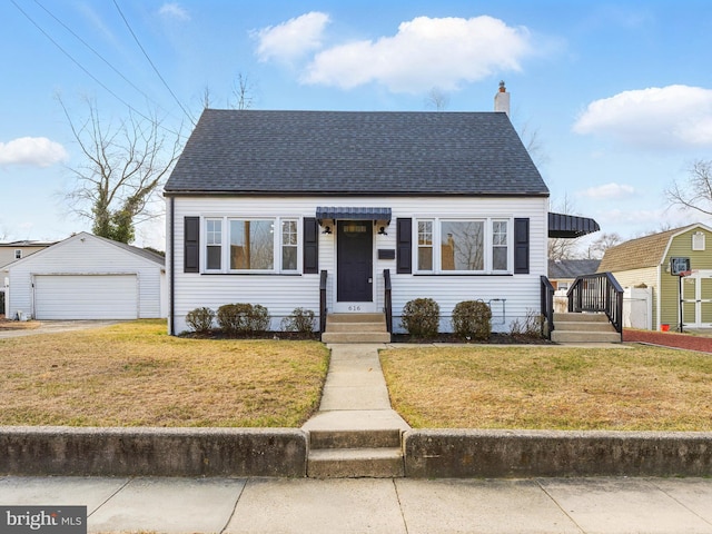 bungalow-style home featuring a chimney, an outbuilding, roof with shingles, and a front lawn