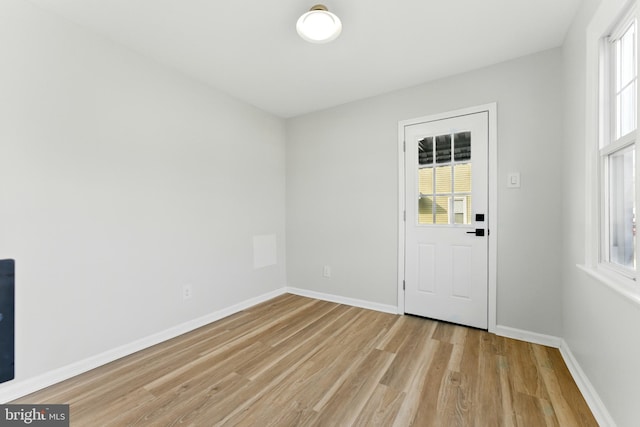 entrance foyer featuring a wealth of natural light, baseboards, and light wood-style flooring