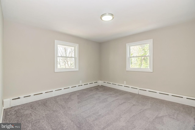 carpeted spare room featuring plenty of natural light